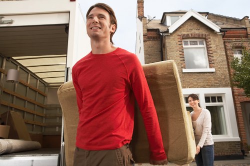 Specialist movers protecting a piano during loading for removals