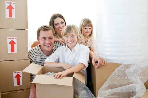 Professional movers packing household items for relocation